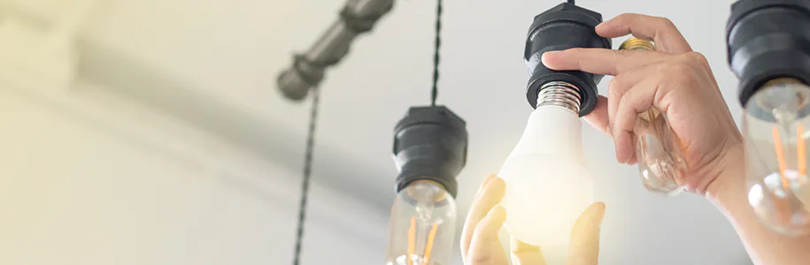 Halogenlampe durch eine LED ersetzt Mann ersetzt Halogenlampe durch eine LED